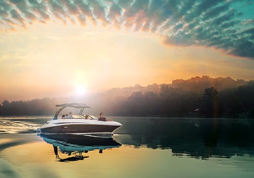 Cabin cruiser at sail beneath an interesting cloud formation