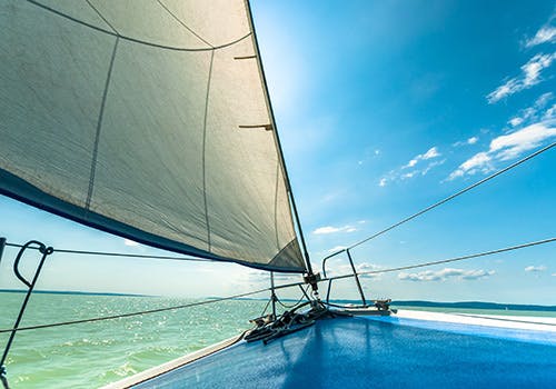 A view across the mast of sailboat at sea