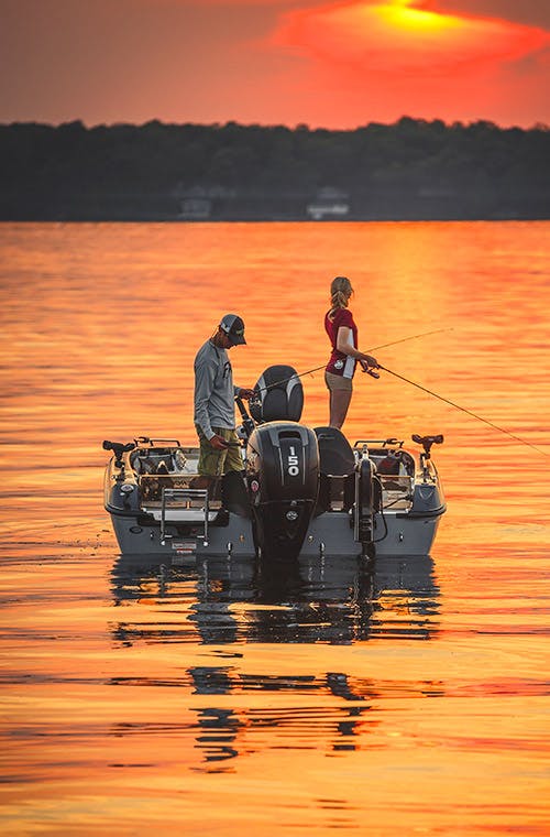 Couple fishing at sunset